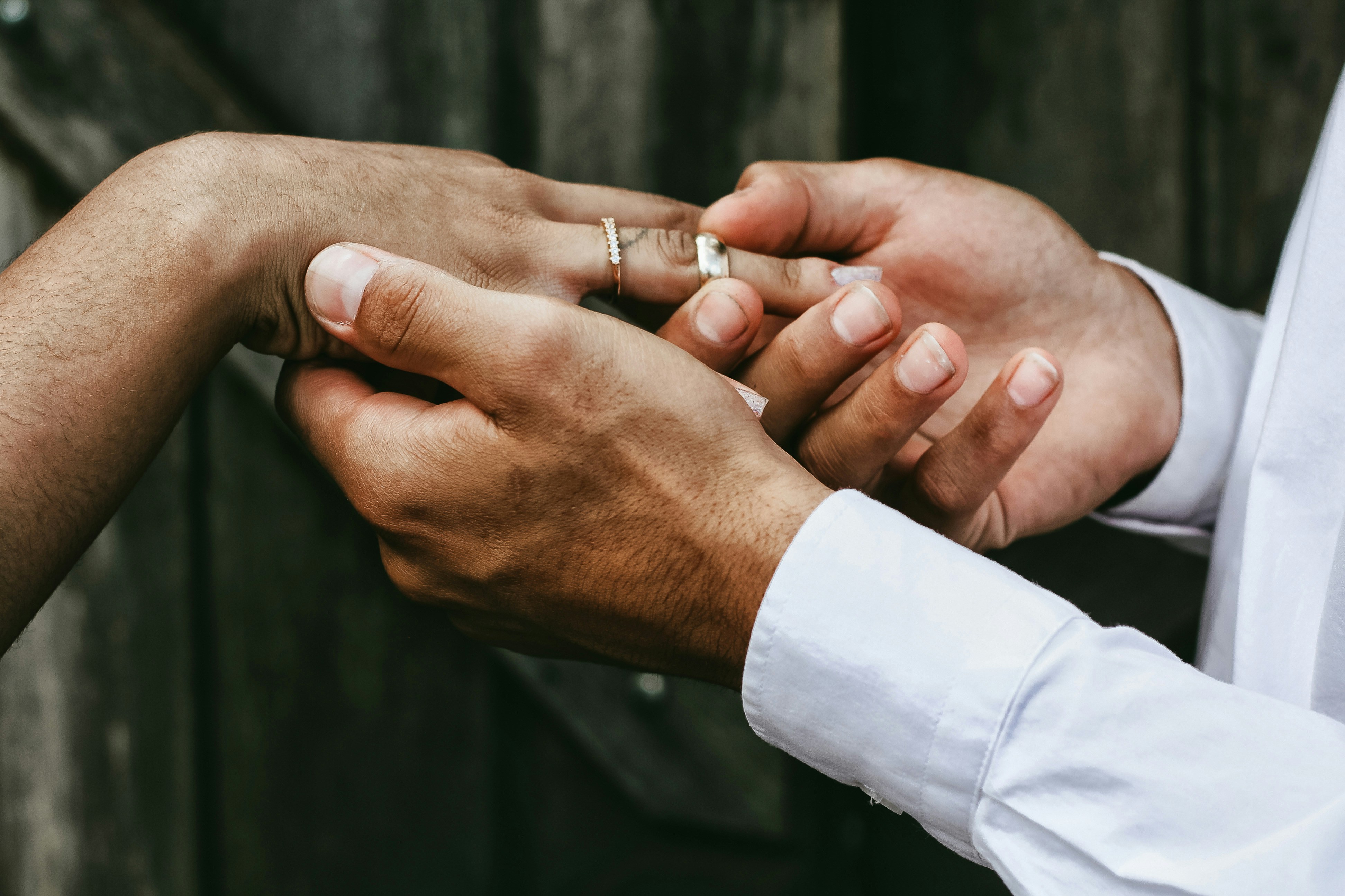 close up image of man putting an engagement ring on a woman after Valentine's Day proposal