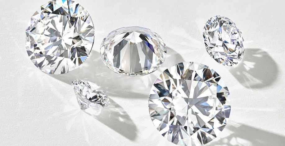 Diamonds of various sizes scattered across a white surface