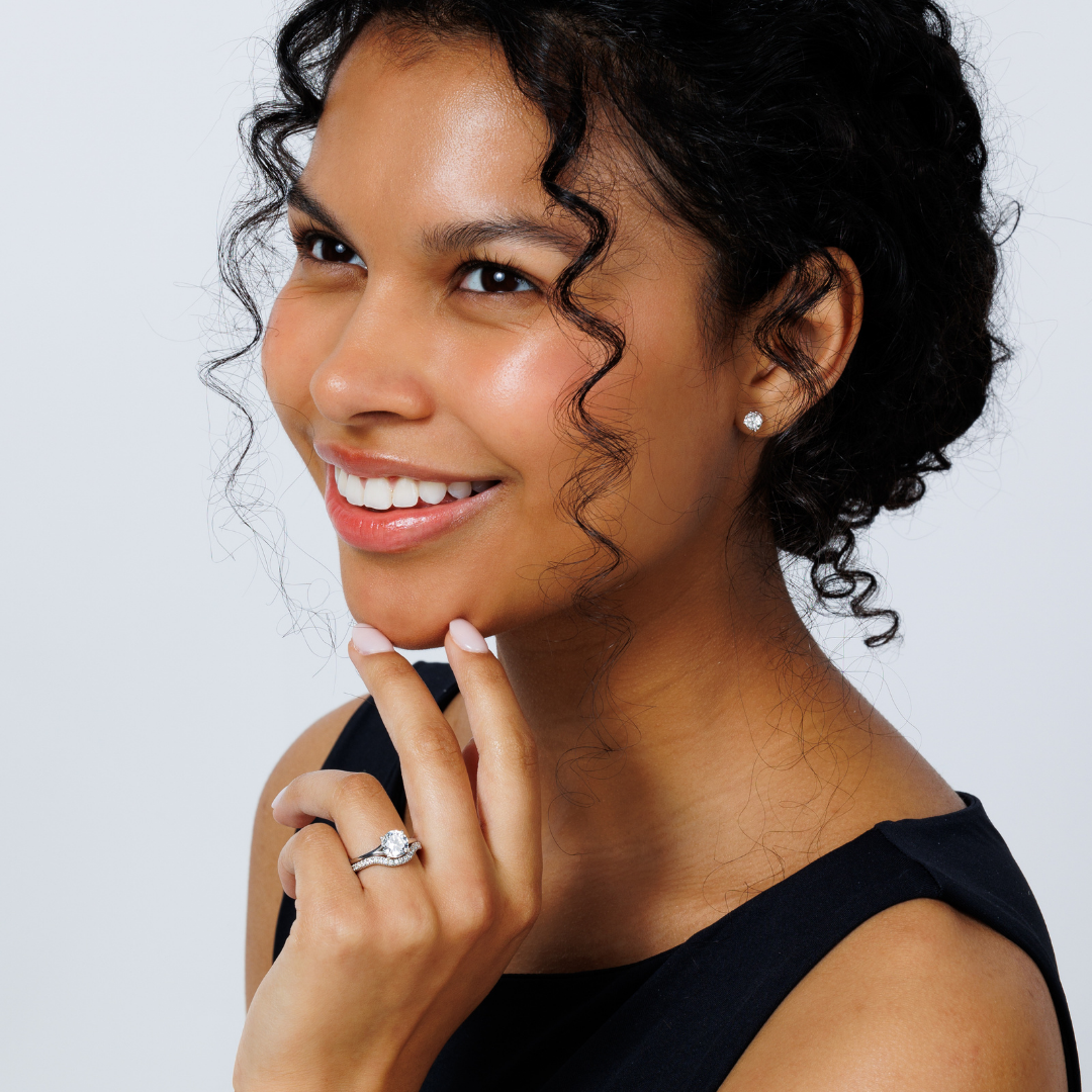 A woman wearing a diamond engagement ring on her ring finger