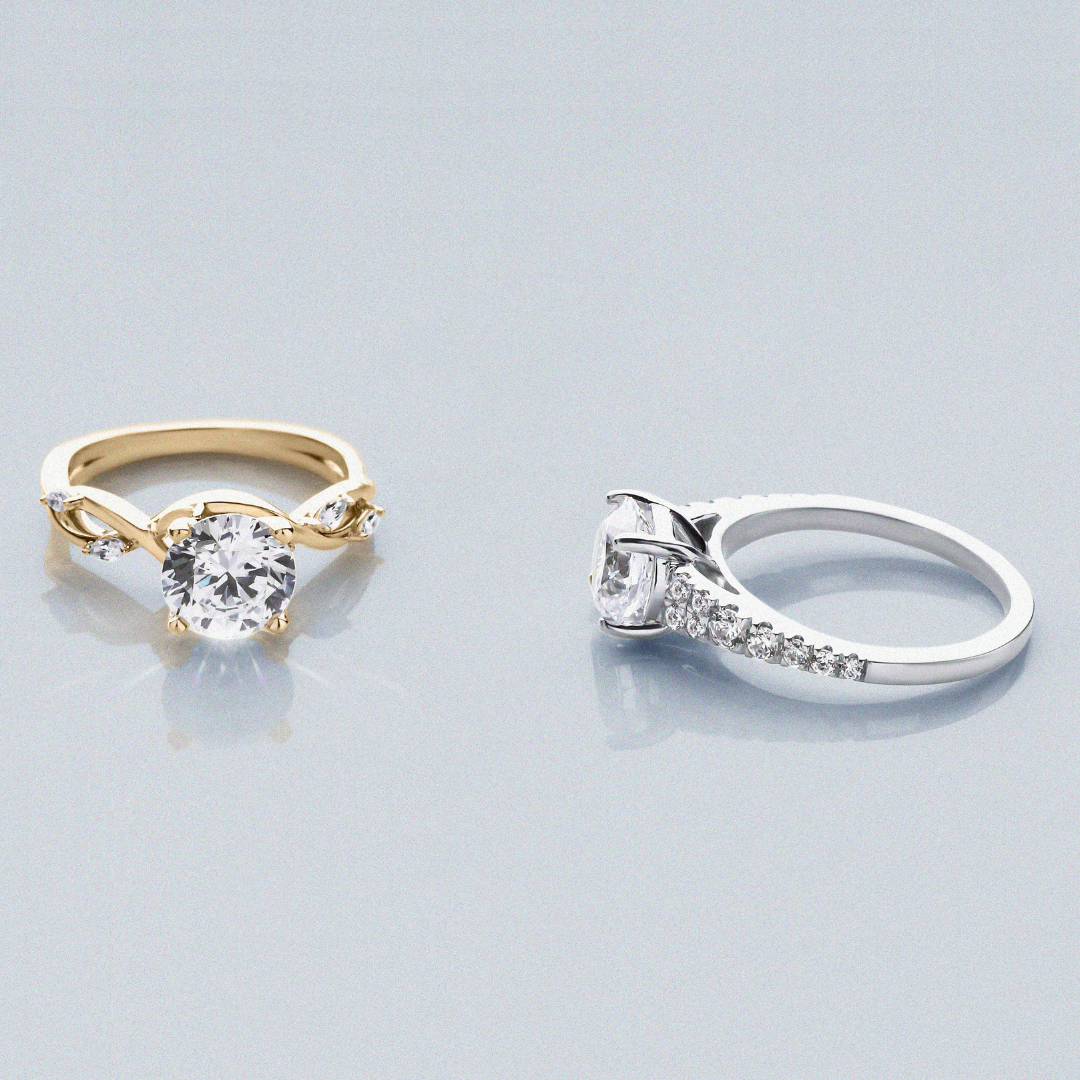 Two diamond engagement rings: one in a yellow gold setting (left) and one in a white gold setting (right)