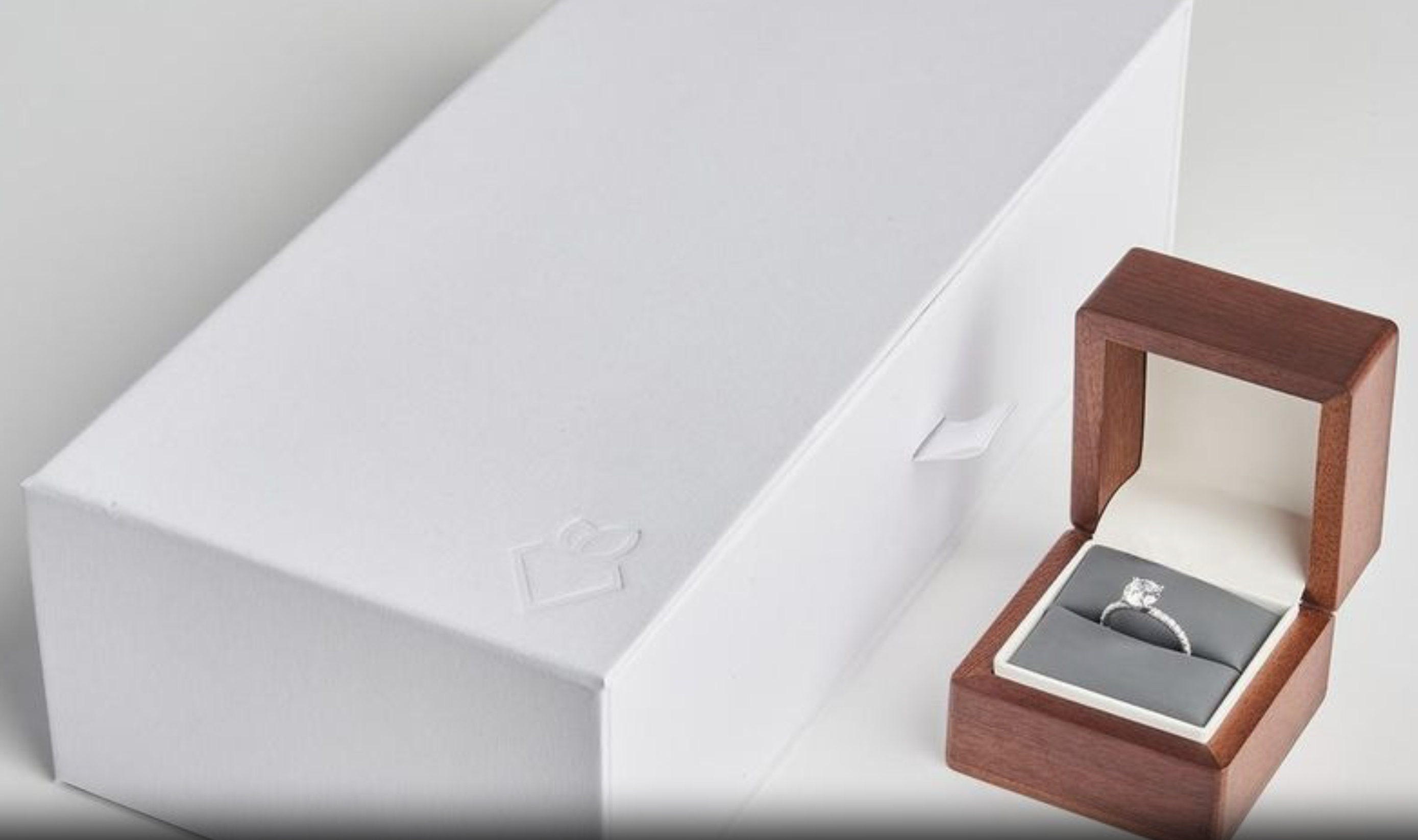 A diamond engagement ring in a Rare Carat ring box and packaging