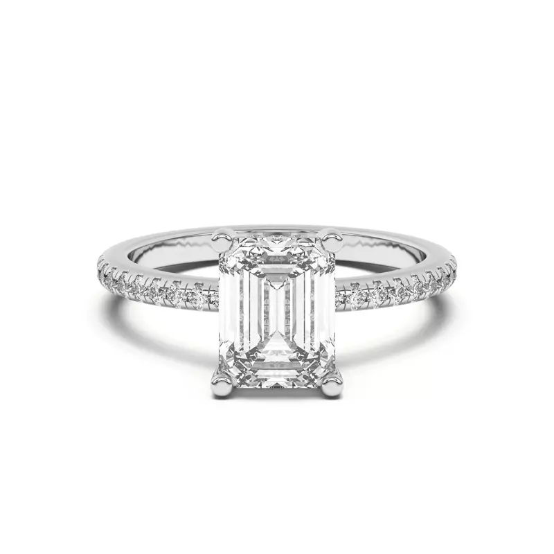 Emerald cut diamond in a prong setting with a pave band