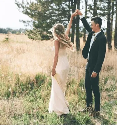 Man putting a ring on the women's finger after Valentine's Day proposal