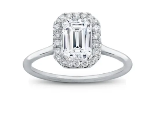 An emerald cut diamond ring with a halo in white metal 