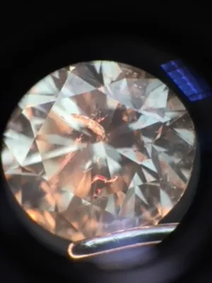 A fracture filled diamond showing the tell tale pink flashes under a microscope
