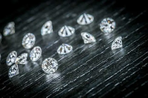 Loose round brilliant diamonds on a black surface