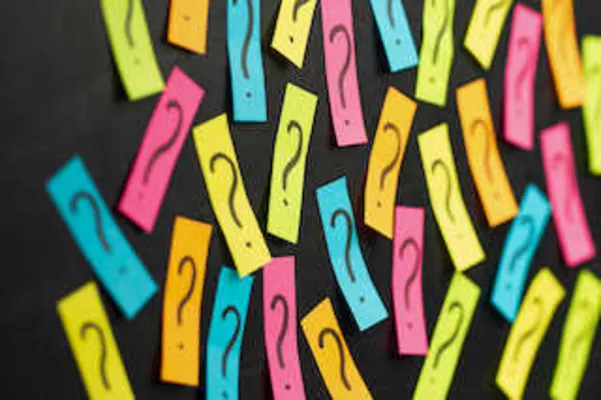 Image of colored post-it notes with question marks drawn on them with black marker