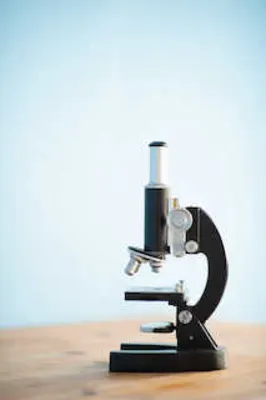 Image of a microscope on wooden table