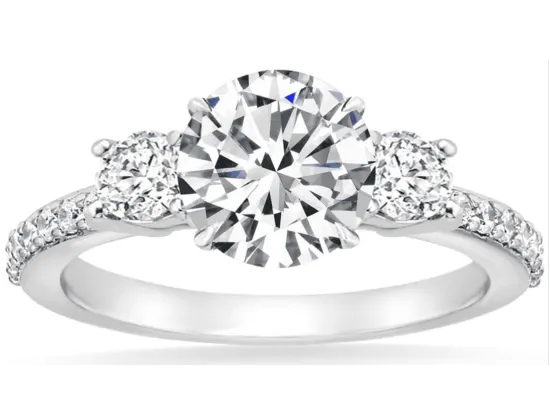 three stone round diamond ring with pave set in white metal 