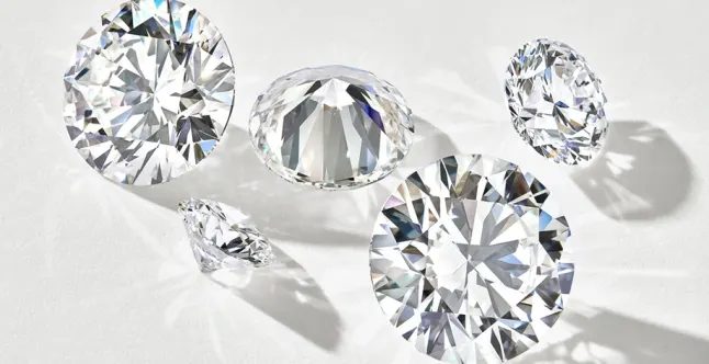 Five diamonds of varying sizes placed on a white background