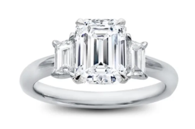 Three stone emerald diamond ring set in white metal 