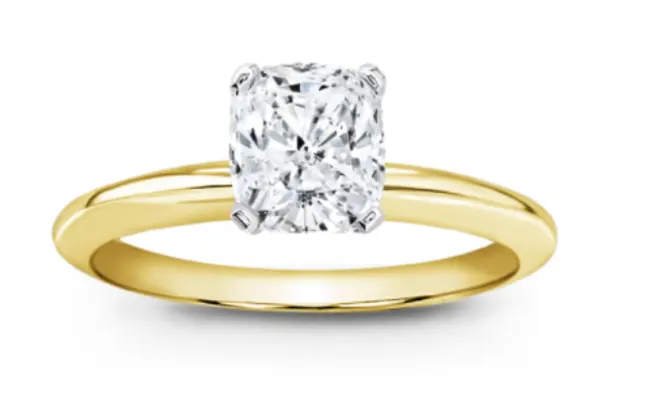 Cushion cut diamond set in a white gold head on a yellow gold ring. (2 tone)