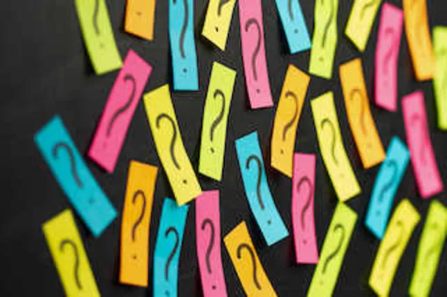 Image of colored post-it notes with question marks drawn on them with black marker