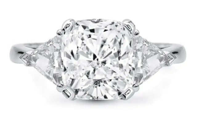 Cushion cut center stone with a trillion cut diamond flanking each side in white metal (3 stone)