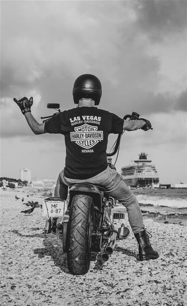 Photo of a man on a motor cycle on a beach