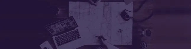 blog header with laptop and map on table