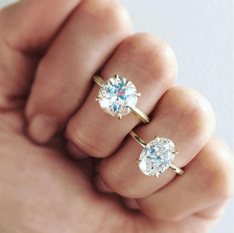 Oval vs. round diamond on a woman's fingers