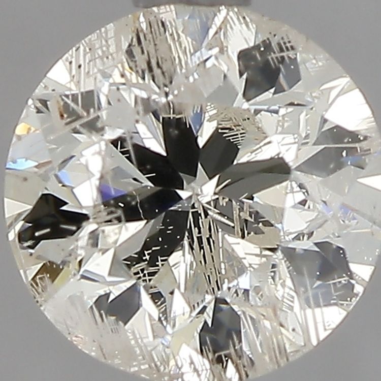 Round diamond that has jagged white lines throughout due to laser drilling