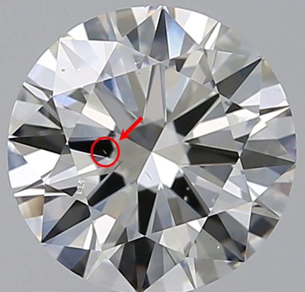 Round diamond against a gray background with red circle around a diamond needle with arrow pointing to it