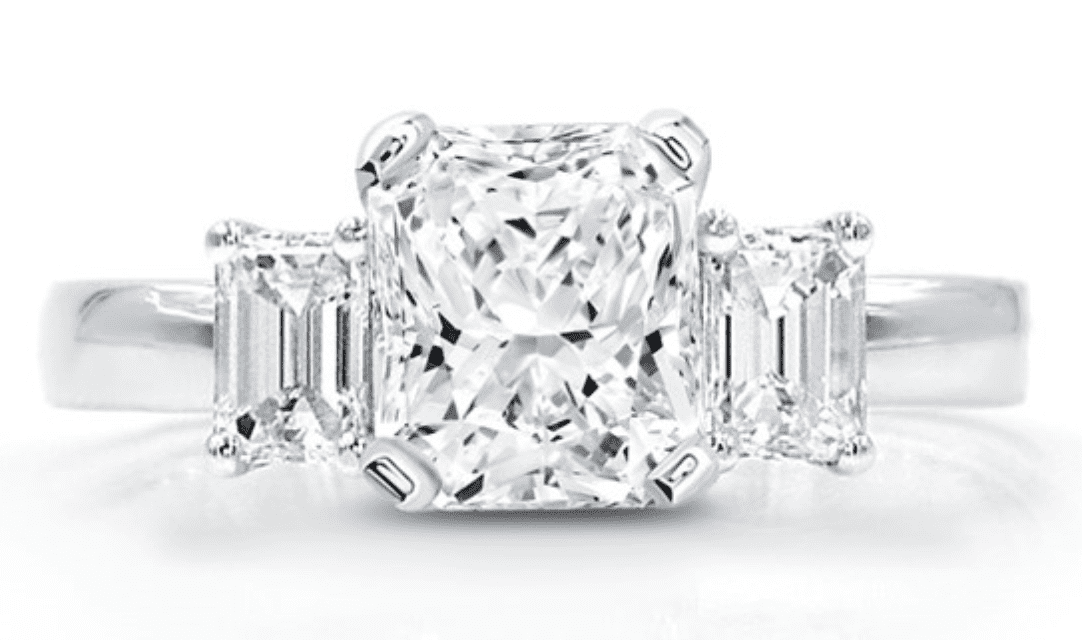 a radiant center stone with emerald cut flanking it. 3 stone