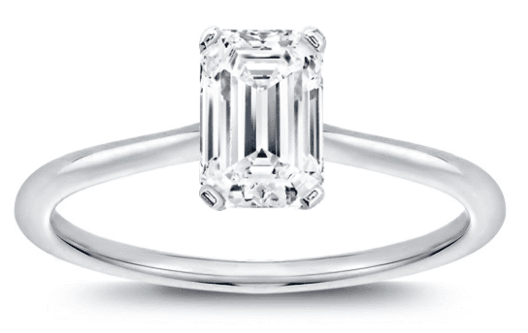 An emerald cut solitaire ring in white gold setting