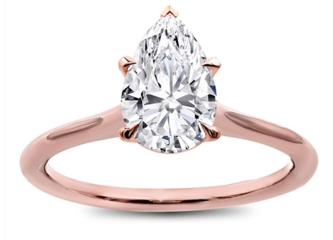 A pear cut solitaire diamond ring in rose gold setting