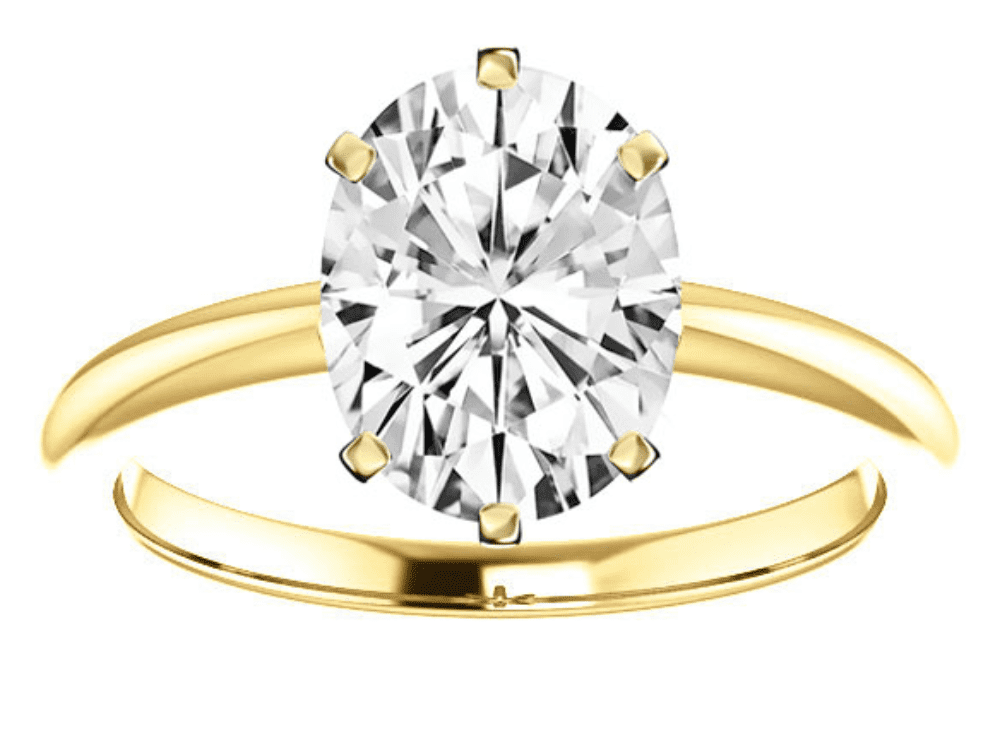 An oval shaped diamond set in 6 prongs in a yellow gold ring
