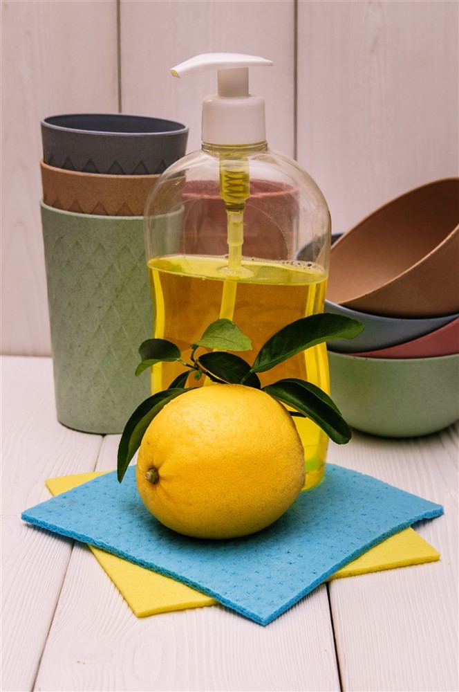 A bottle of dish soap with a lemon