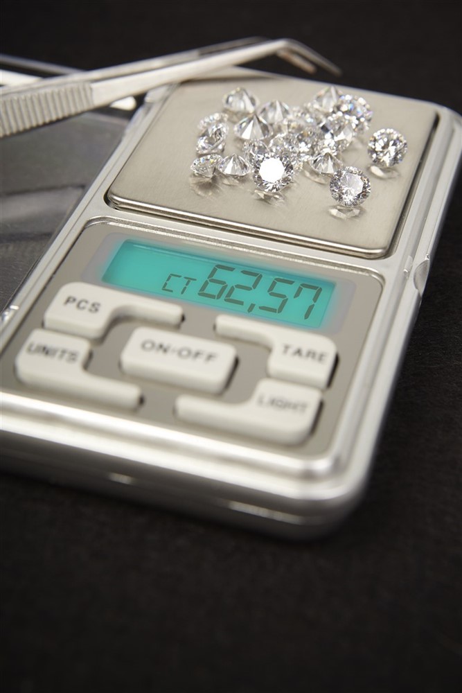 Loose diamonds being weighed on a scale