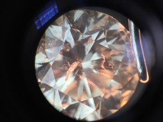 A fracture filled diamond showing the tell tale pink flashes under a microscope