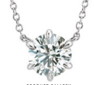 A Solitaire diamond pendant, set against a white background