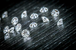 loose diamonds scattered on a black surface