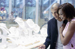 A couple looking at a jewelry store display
