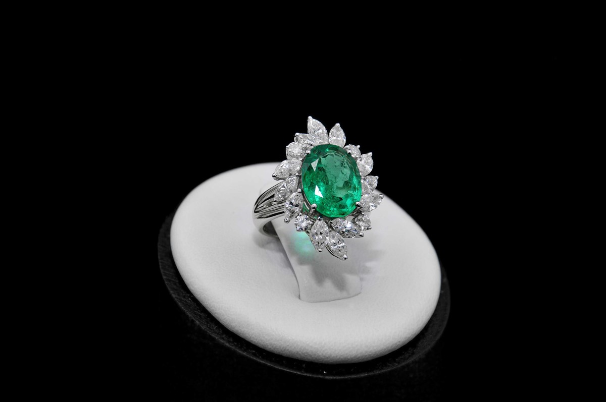 An emerald and diamond ring