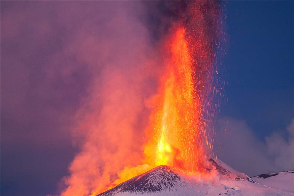 A volcano erupting lava fountain