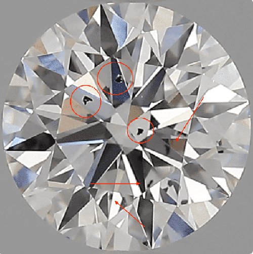 A close-up of a diamond to show big black inclusions