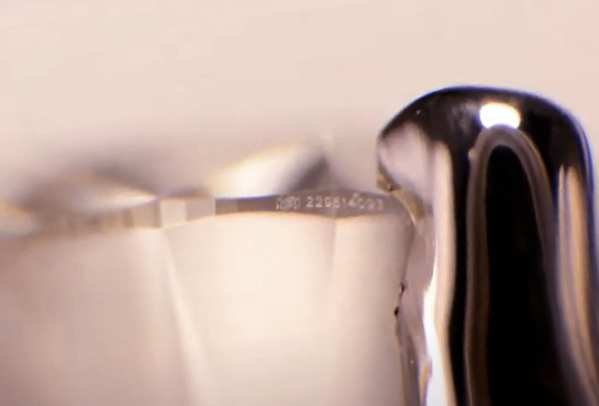 A close-up image of a laser inscription on a diamond